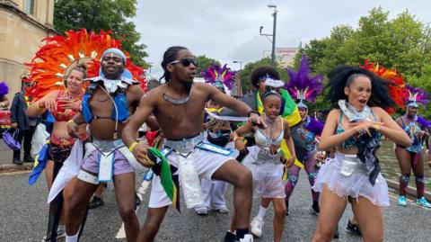 Dancers processing through the streets