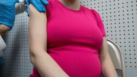 Pregnant woman getting vaccine