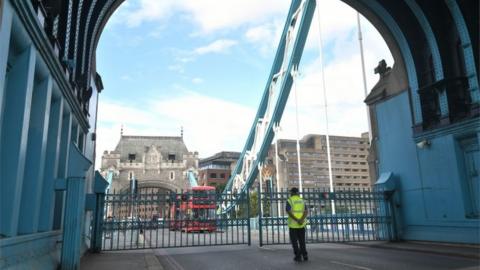 Traffic queuing behind the locked gates of Tower Bridge