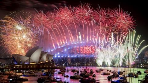 Fireworks explode over the harbour and the Sydney Harbour Bridge landmark during New Year celebrations in Sydney, Australia