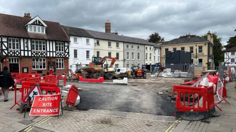 An image of roadworks in Leominster town centre, which shows barriers and roadworks signs