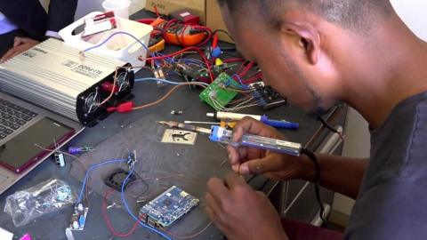 A worker assembling electrical components