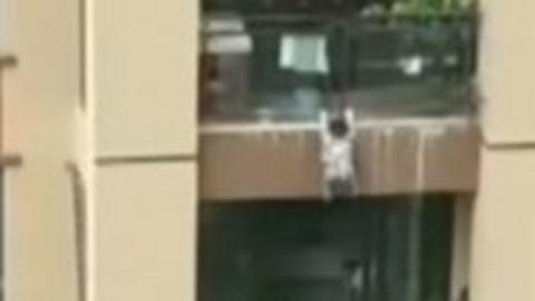 Toddler hanging off balcony