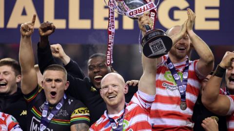 Wigan captain Liam Farrell lifts the World Club Challenge