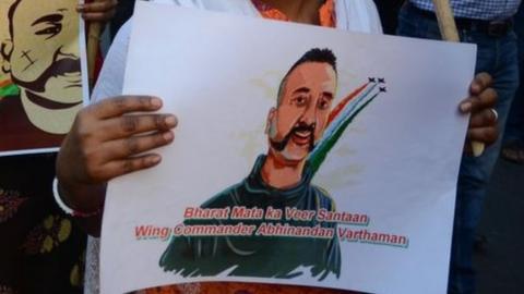 People holding posters of Wing Commander Abhinandan Varthaman celebrate his return at a rally in Kolkata on 2 March 2019.