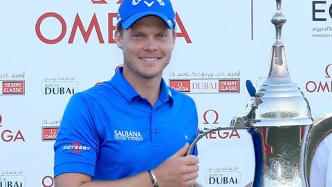 English golfer Danny Willett celebrates winning the Omega Dubai Desert Classic