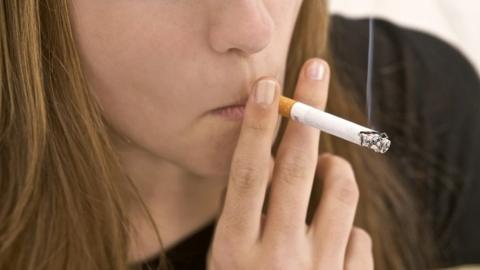 Young woman smoking a cigarette