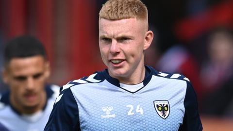 Alfie Bendle warms up before an AFC Wimbledon match