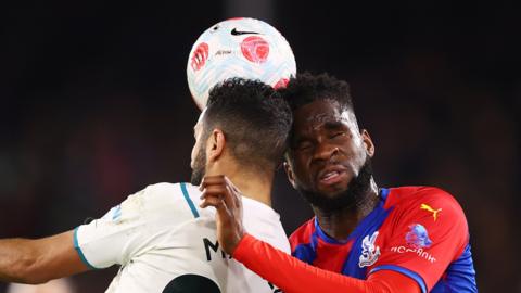 Riyad Mahrez of Manchester City and Odsonne Edouard of Crystal Palace compete for a header