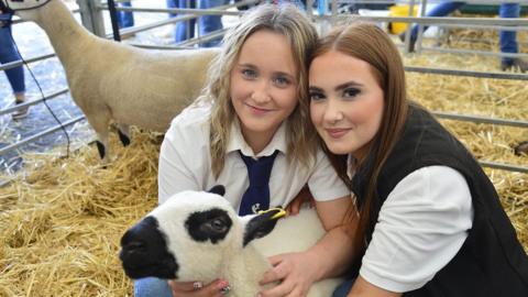 Two sisters with a lamb at Balmoral Show