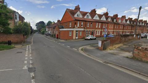 Road junction with terraced houses lining a road to the right and straight ahead along Winterborne Road in Abingdon.
