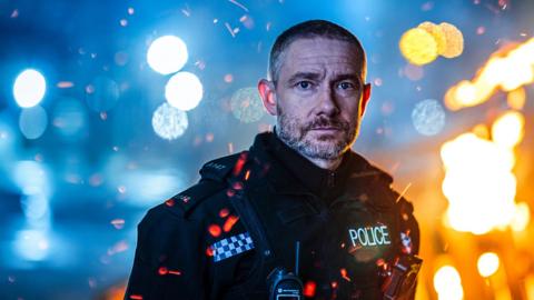 A police officer looking at the camera