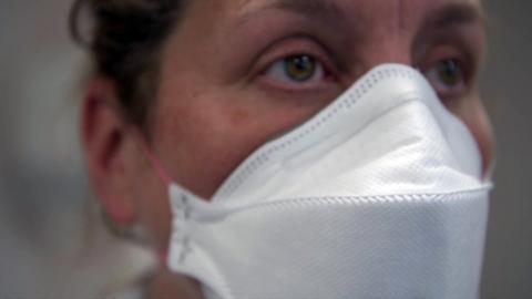 Close up of woman wearing a mask