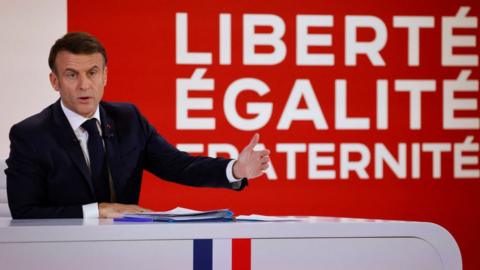 rance's President Emmanuel Macron gestures as he speaks during a press conference to present the course for France's newly appointed government