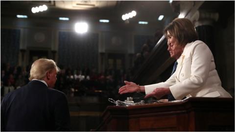 Trump turns away from Pelosi as she holds out her hand