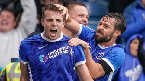 Portsmouth players celebrate scoring in League One.