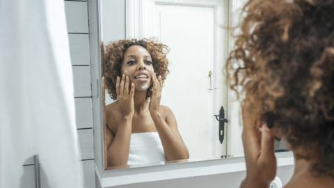 Woman using face cream.