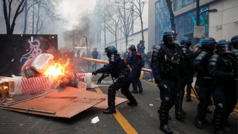 Police officers remove a barricade during a demonstration against the "Global Security Bill"", that right groups say would make it a crime to circulate an image of a police officer"s face and would infringe journalists" freedom in the country, in Paris, France, on 5 December 2020.