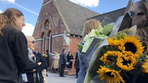 Mourners at the funeral of an unidentified woman