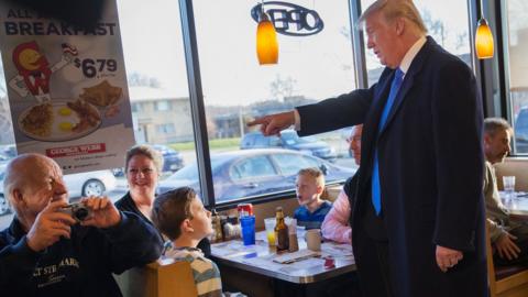 Republican presidential candidate Donald Trump chats with patrons and workers at a George Webb diner following an interview with Fox News on April 5, 2016 in Wauwatosa, Wisconsin