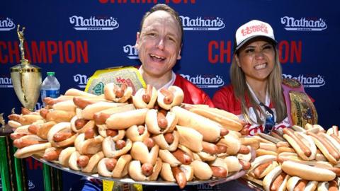 Joey Chestnut from Indiana (L) and Miki Sudo from Florida (R) with hot dogs