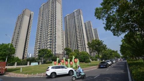 Vehicles pass by the Country Garden Community in Fuyang city, East China's Anhui province, 3 September, 2023.