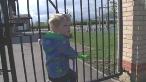 Oscar at gates of school