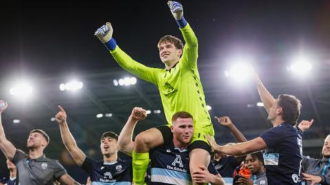 Goalkeeper Zac Jones celebrates with his Haverfordwest team-mates.