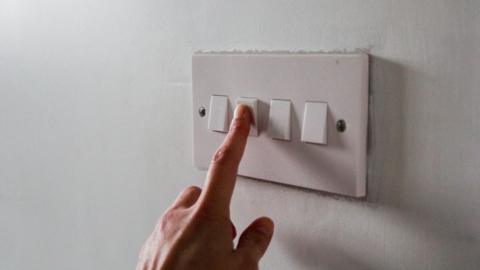 Finger on light switch
