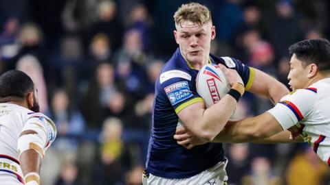 James McDonnell runs at the Wakefield defence with Mason Lino making a tackle