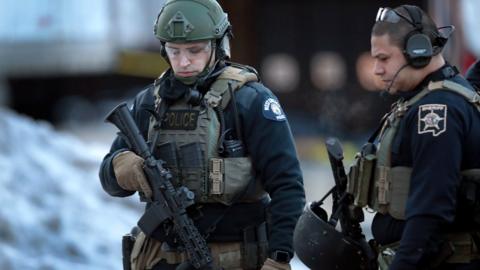 Police secure the area following a shooting at the Henry Pratt Company in Aurora, Illinois, 15 February 2019