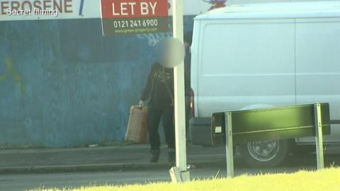 A motorist carrying a petrol can