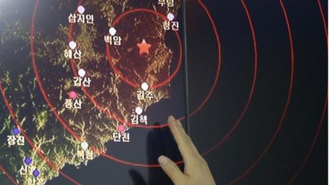 In this Friday, Sept. 9, 2016, file photo, an official of the Earthquake and Volcano of the Korea Monitoring Division points at the epicenter of seismic waves in North Korea, in Seoul, South Korea.