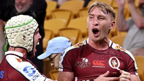 Tate McDermott of the Reds is congratulated by team mates after scoring a try during the round one Super Rugby Pacific match between Queensland Reds and NSW Waratahs at Suncorp Stadium, on February 24, 2024, in Brisbane, Australia.