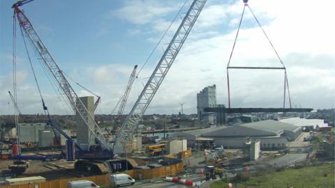 One of the steel pieces being lifted by a crane