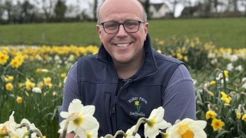 Dave hardy in a field of daffodils