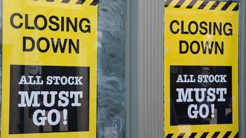 closing down signs in shop window