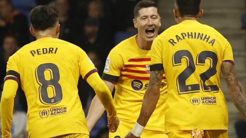 Robert Lewandowski celebrates with his Barcelona team-mates after scoring against Espanyol