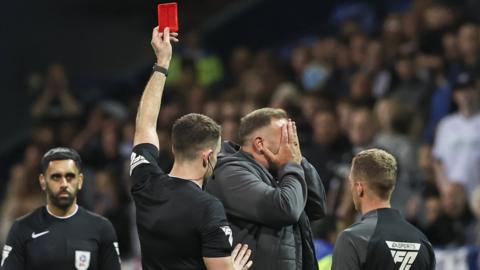 Bolton boss Ian Evatt holds his face to his hands after his dismissal against Fleetwood