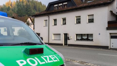 A police car sits on 13 November 2015 in front of a house in Wallenfels, southern Germany, where the bodies of infants were discovered the day before