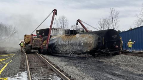 Officials inspect the crash site of the East Palestine, Ohio train derailment.