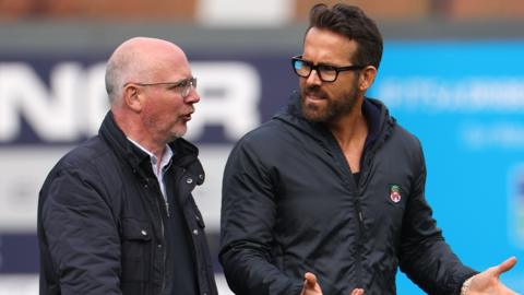 Shaun Harvey (left) with Ryan Reynolds on the pitch at the Racecourse.