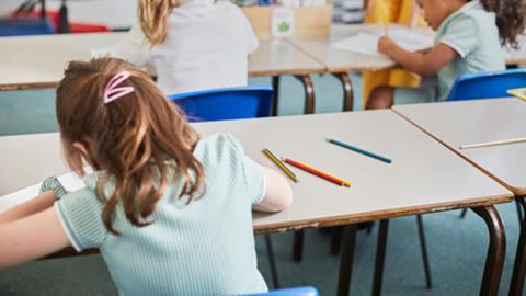 Girl writing in classroom