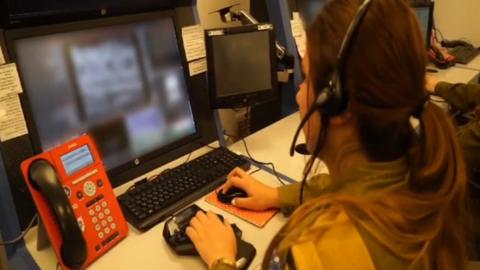 An Israel Defense Forces field observer looks at a monitor inside a "war room" near Israel's northern border with Lebanon