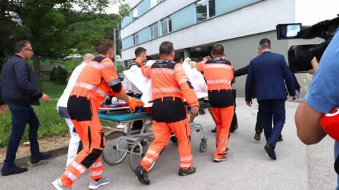 Picture taken on 15 May 2024 shows Slovak Prime Minister Robert Fico being transported by medics and his security detail to the hospital in Banska Bystrica, Slovakia where he is to be treated after he had been shot "multiple times"