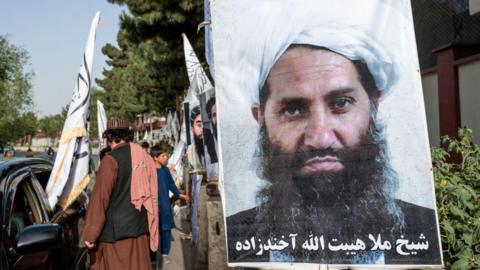 A poster of Taliban Supreme Leader Hibatullah Akhundzada is seen along a road in Kabul on 14 August 2023