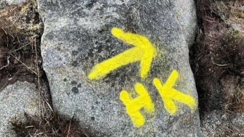 Visible yellow marker on rocks along route of Goatfell