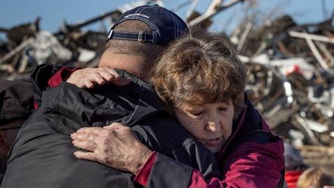 Two tornado survivors hug in Mayfield, Kentucky, 12 December 2021