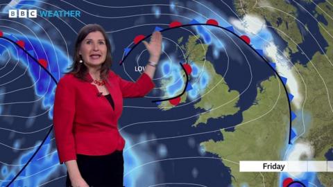 Helen Willetts stands in front of a weather map of the UK