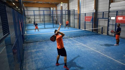 Four people playing padel